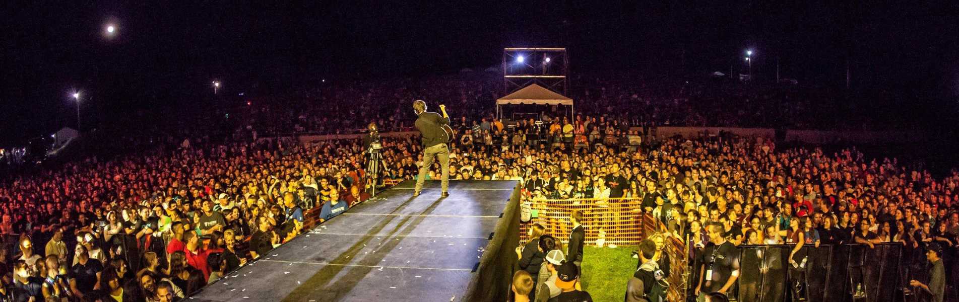Crowd surrounding the stage at night during the Uprise Festival