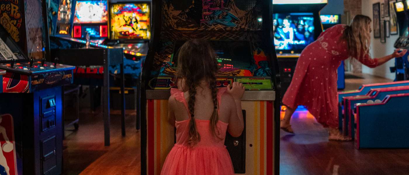 Mother and daughter playing games at Transmission Arcade