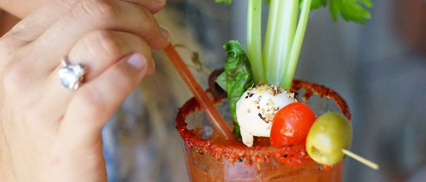 Woman drinking Bloody Mary