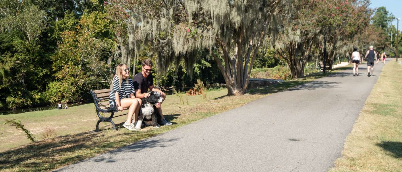 Couple Sitting On A Bench On The Three Rivers Greenway In Columbia, SC