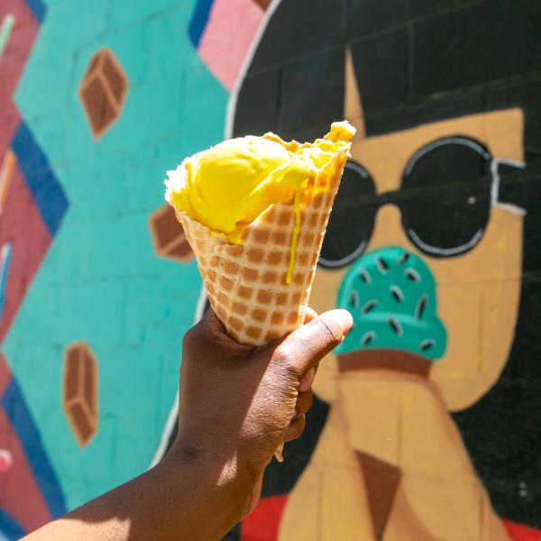 Chocolate Moose ice cream cone held in front of their mural