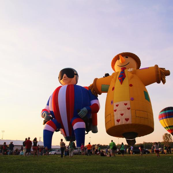 Three hot air balloons launching at the Indiana Kiwanis Balloon Festival