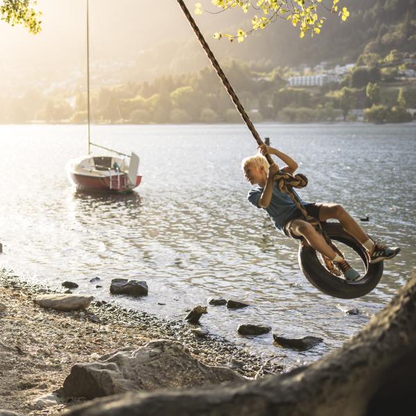 Family playing on rope swing in Queenstown Gardens