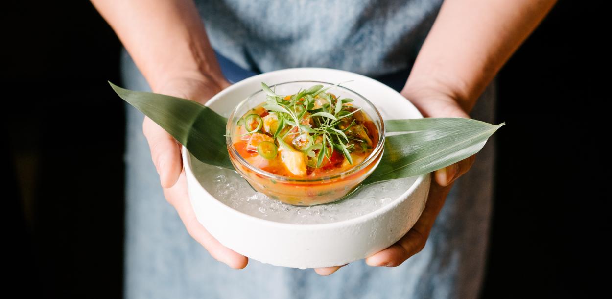 Person holds bowl of ceviche from La Condesa in Austin Texas