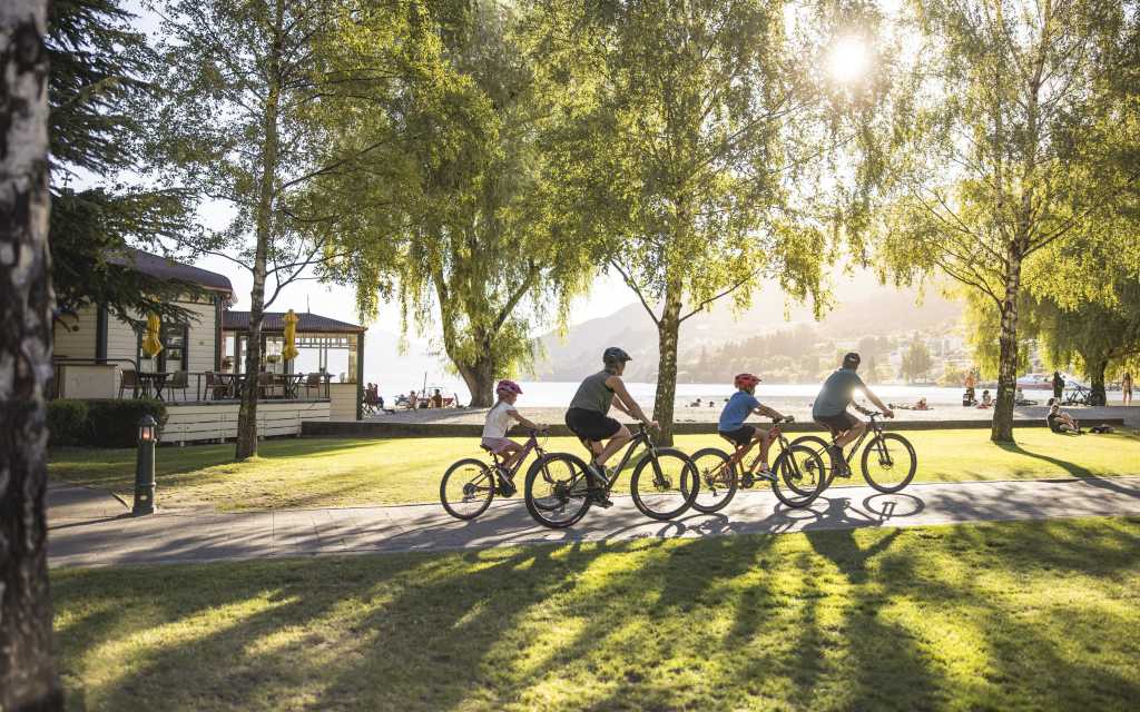 Family biking along Queenstown waterfront