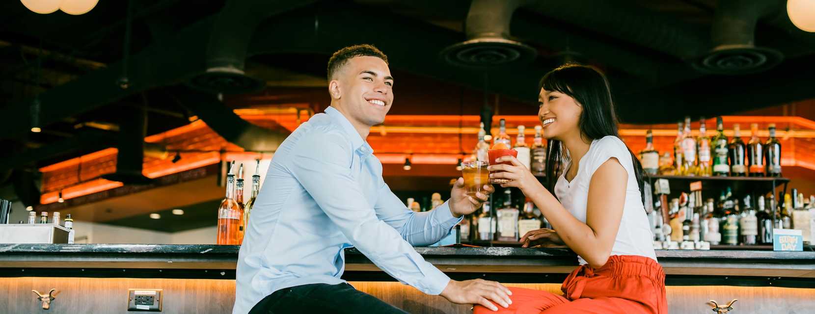 A couple having drinks at a bar