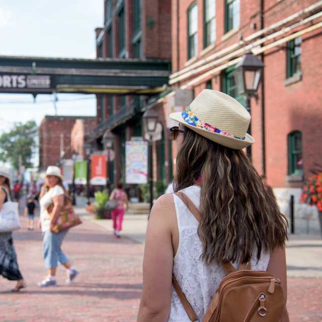 People explore the Distillery Historic District in summer