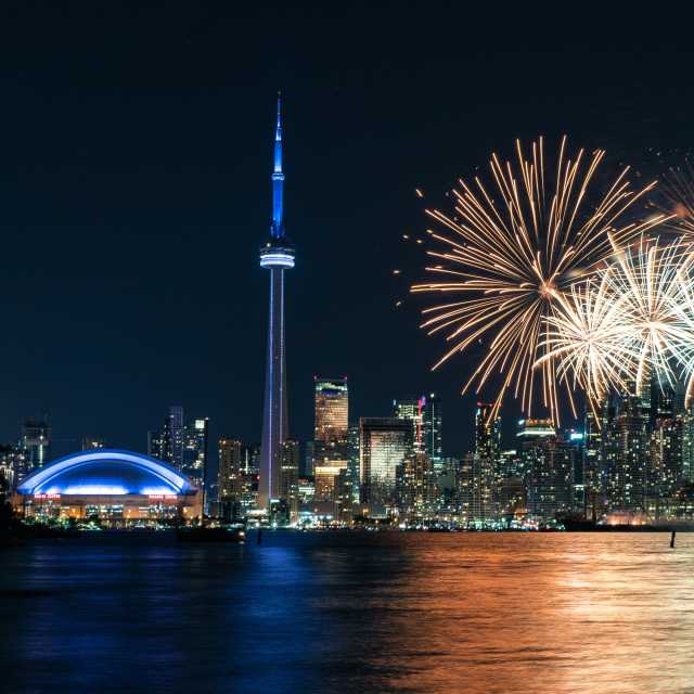 Fireworks explode off the CN Tower at night