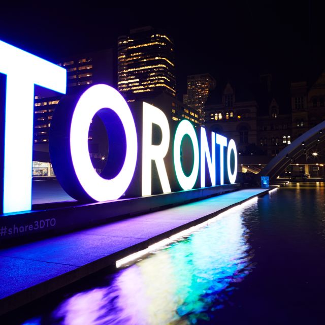 The Toronto Sign at Nathan Phillips Square lit in the evening