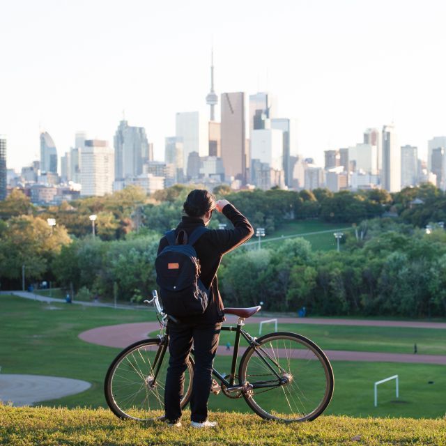 A person looks at the Toronto skyline from Riverdale Park in Toronto's east end