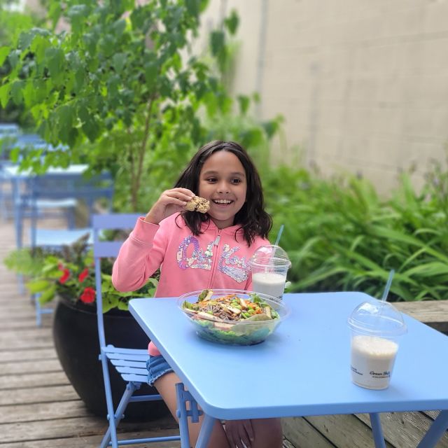 A child eating food on a patio