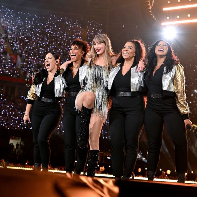 Taylor Swift during the Eras Tour with her backup singers on stage