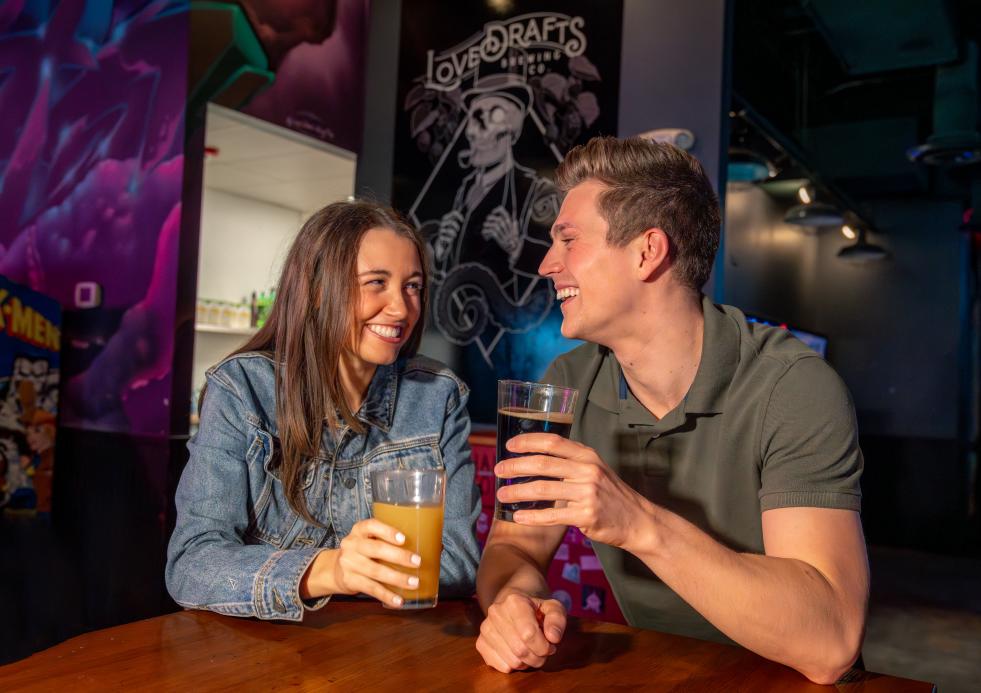 Couple enjoying draft beer and food at Lovedraft's