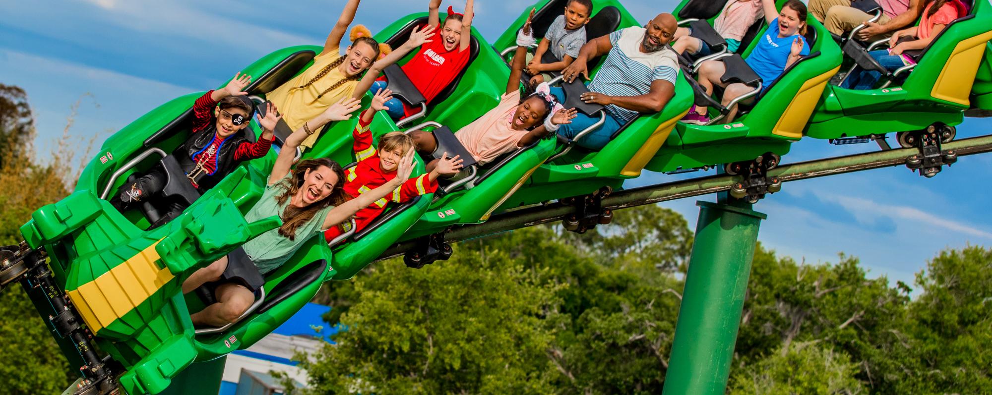 People riding a dragon rollercoaster at Legoland