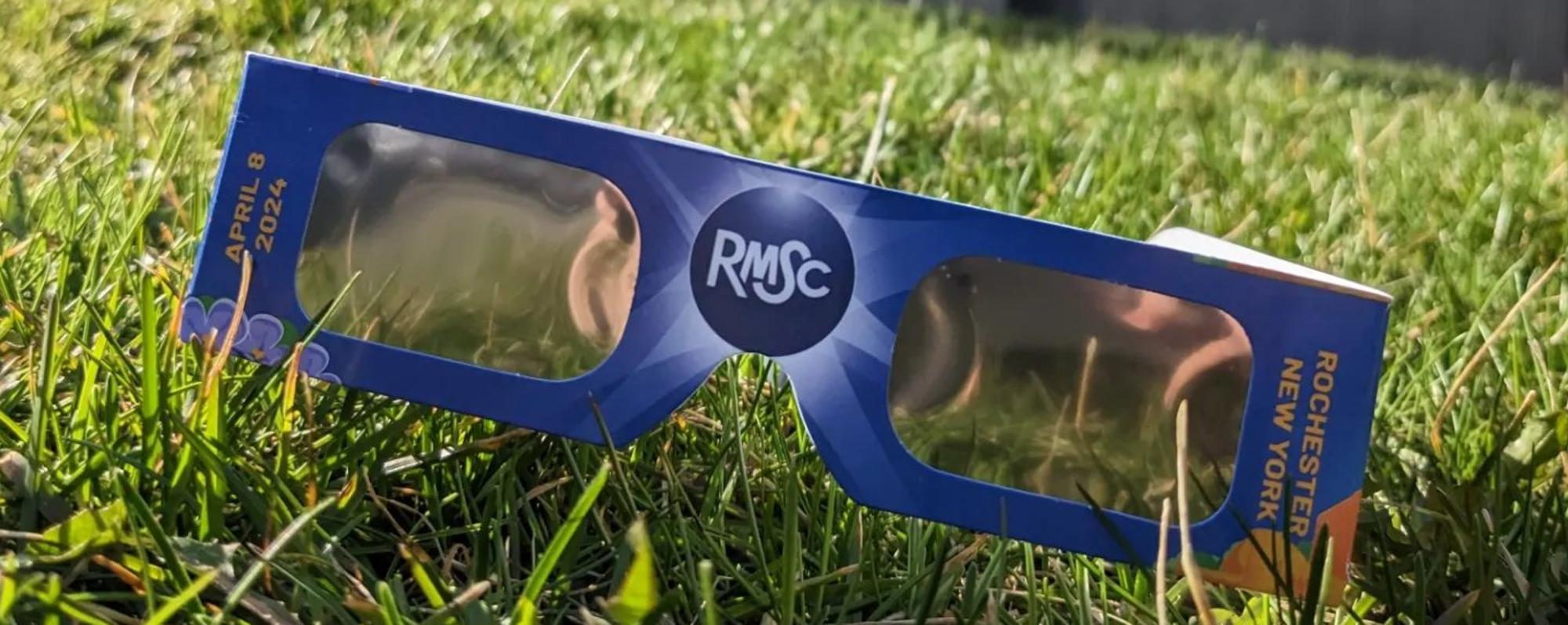 Eclipse viewing glasses on the lawn in front of the RMSC