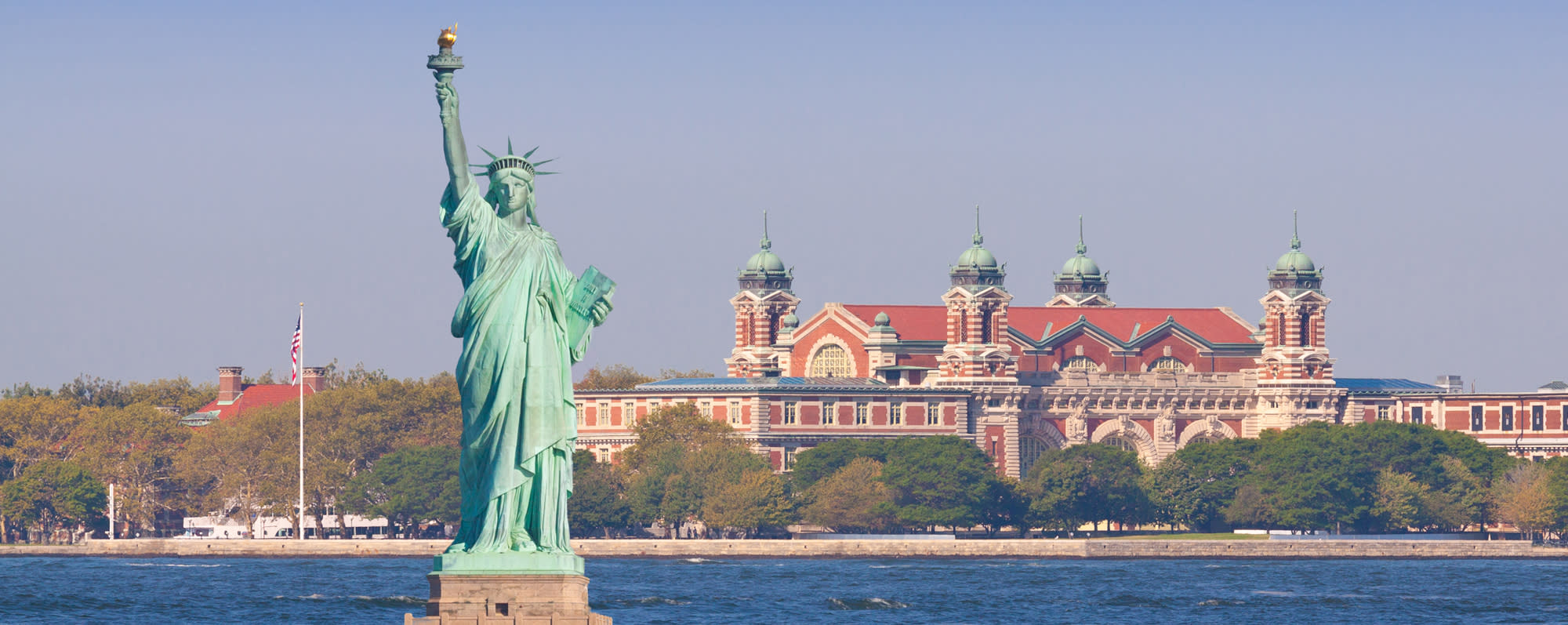 Ellis Island and the Statue of Liberty on a sunny day in New York City
