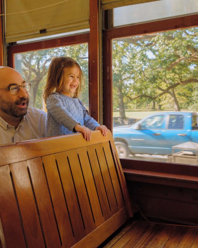 A father and daughter enjoying the St. Charles Avenue Streetcar together
