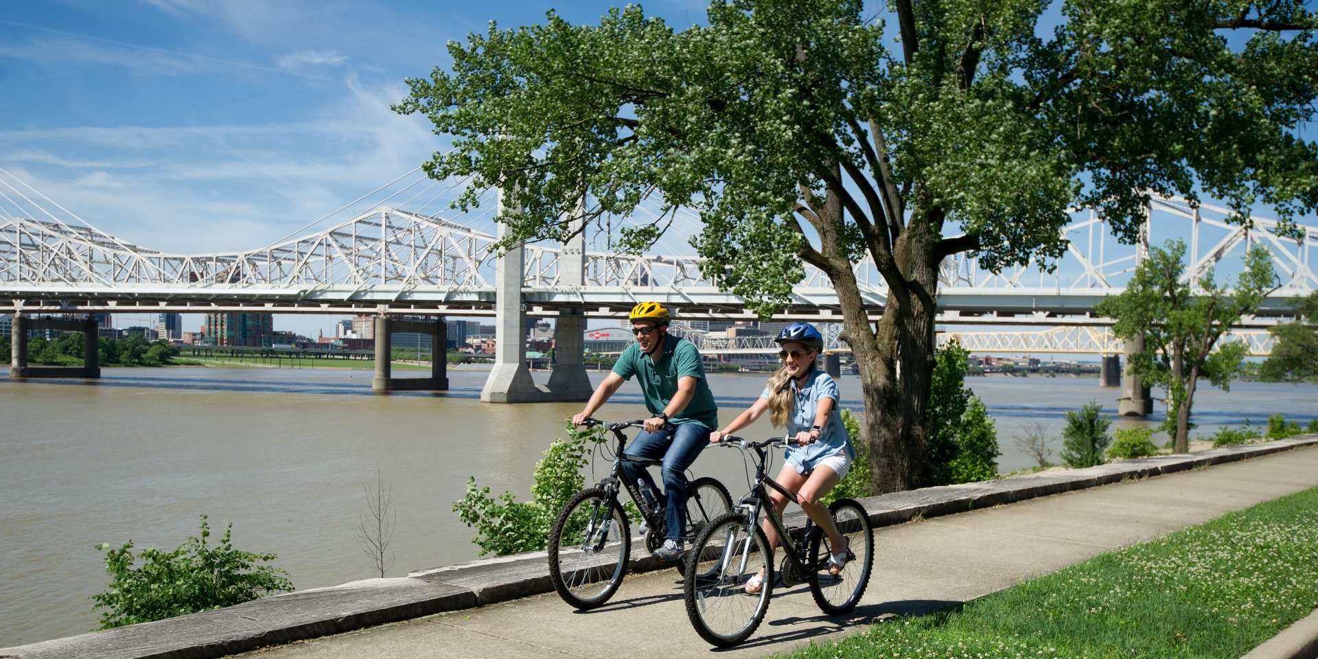 Man and woman riding bikes on the Ohio River Greenway