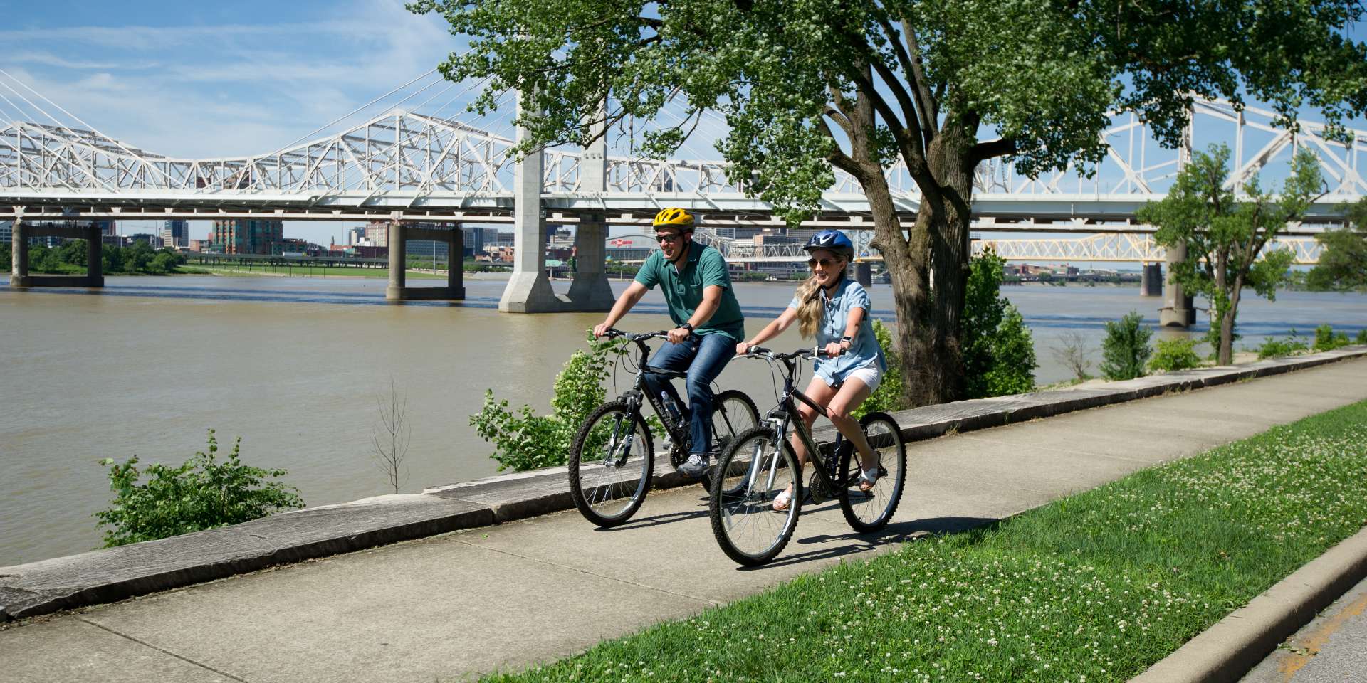 Man and woman riding bikes on the Ohio River Greenway