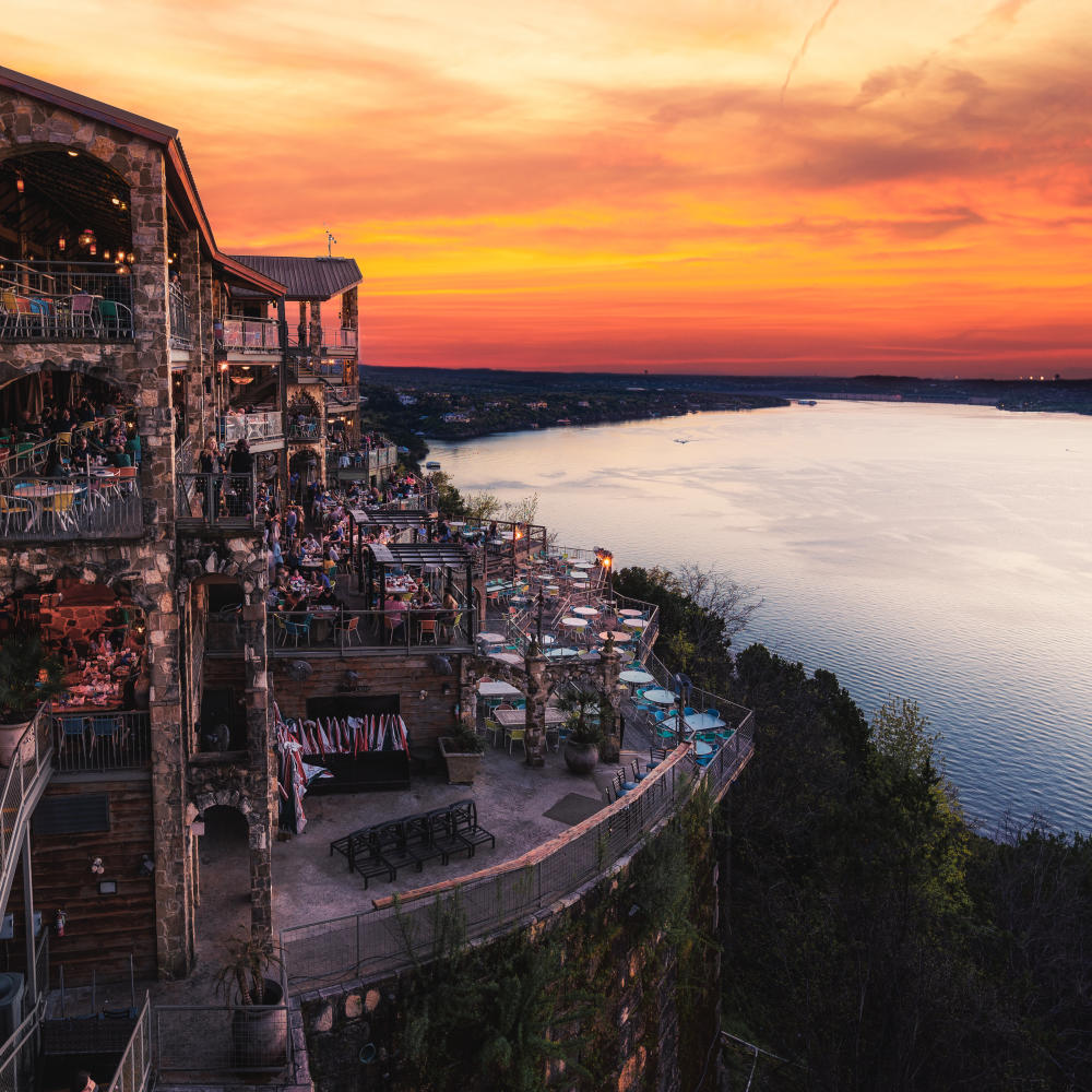 Image of the deck overlooking Lake Travis at the Oasis at sunset.