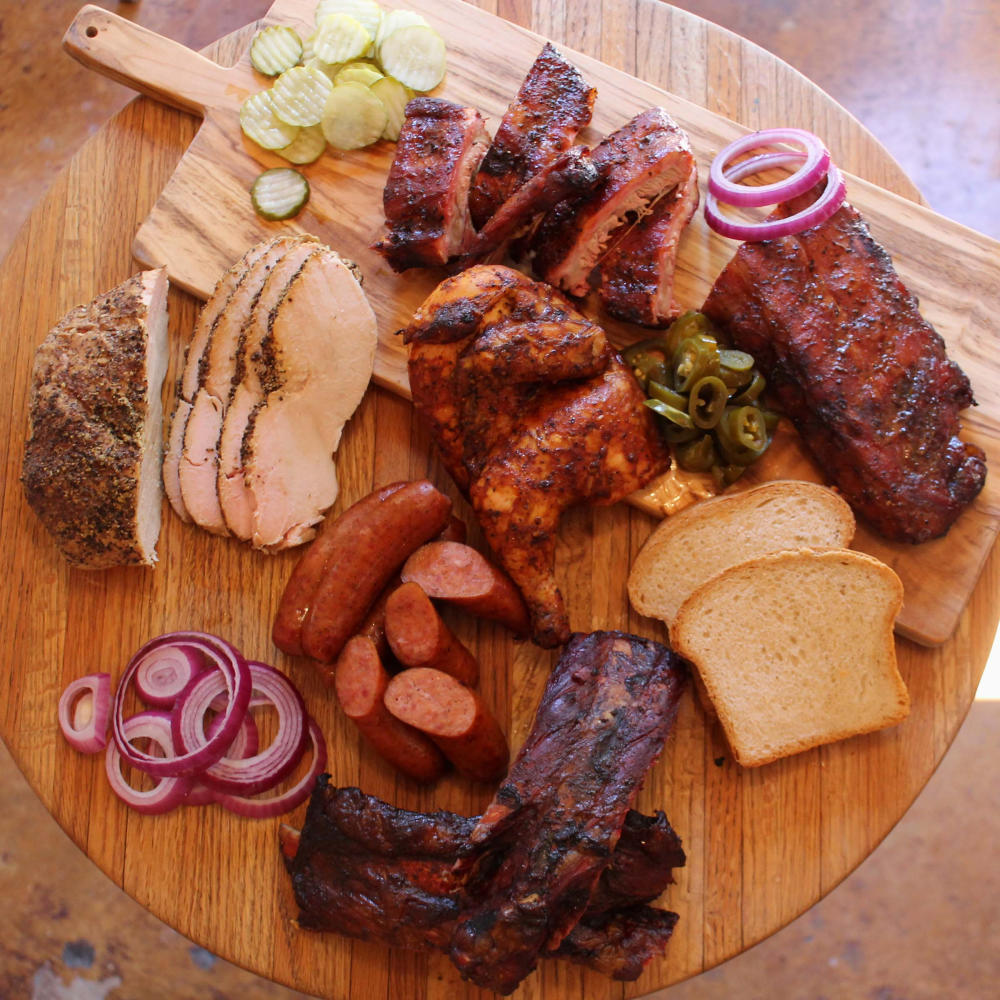 Round table covered in Texas barbecue and fixings.