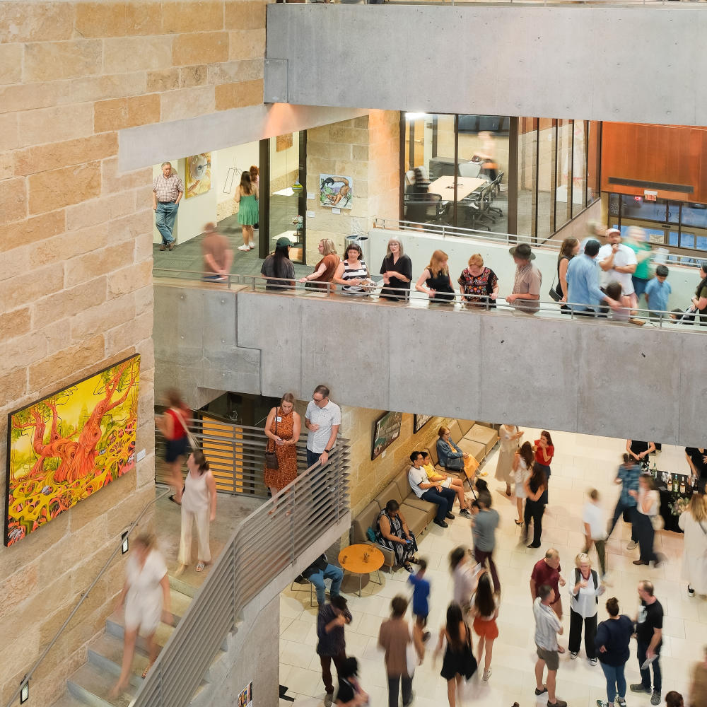 People gathering on different floors of the Austin Public Library.