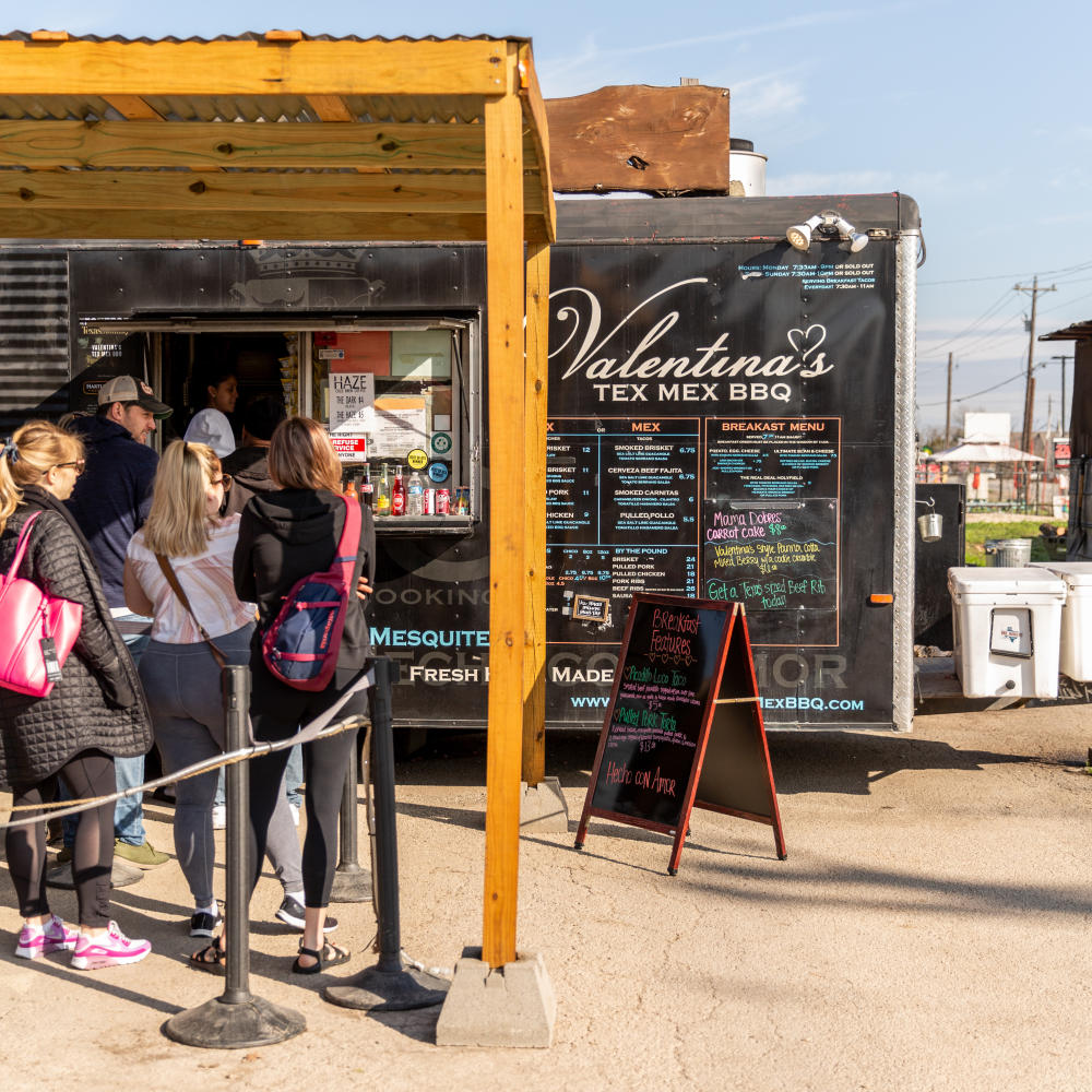 People wait in line at Valentinas Tex Mex BBQ Food Truck in Austin Texas