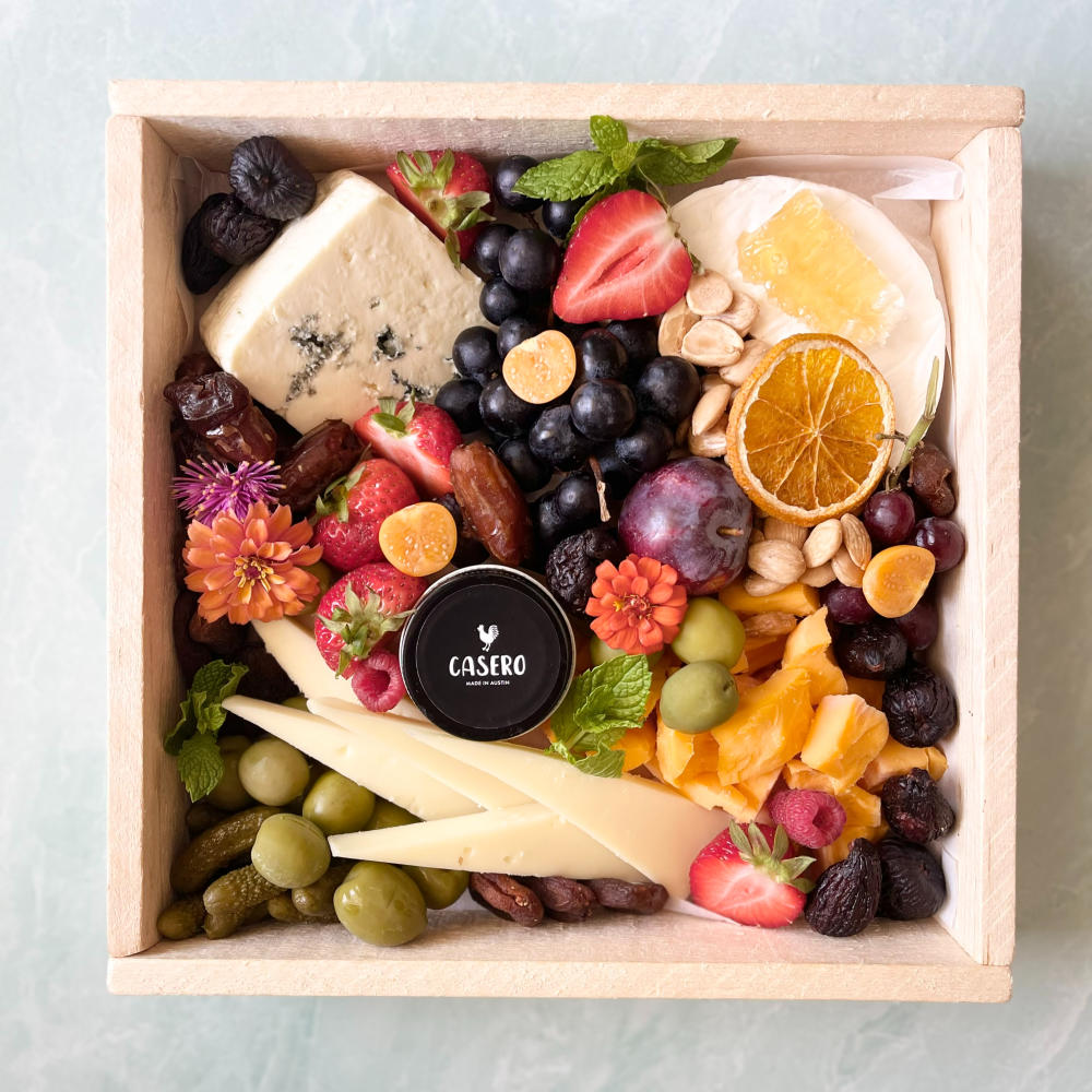 Grazing box with cheeses, fruits and nuts.