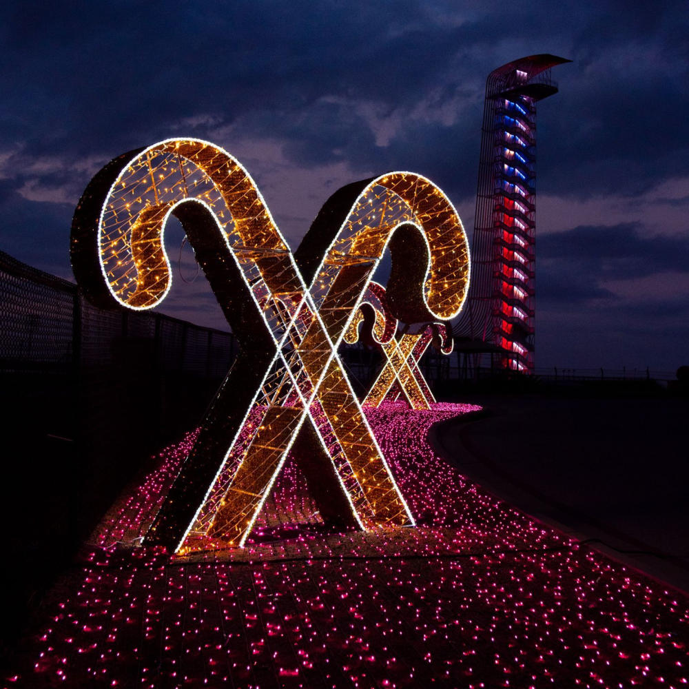 Two giant holiday light candy canes in front of the COTA tower.