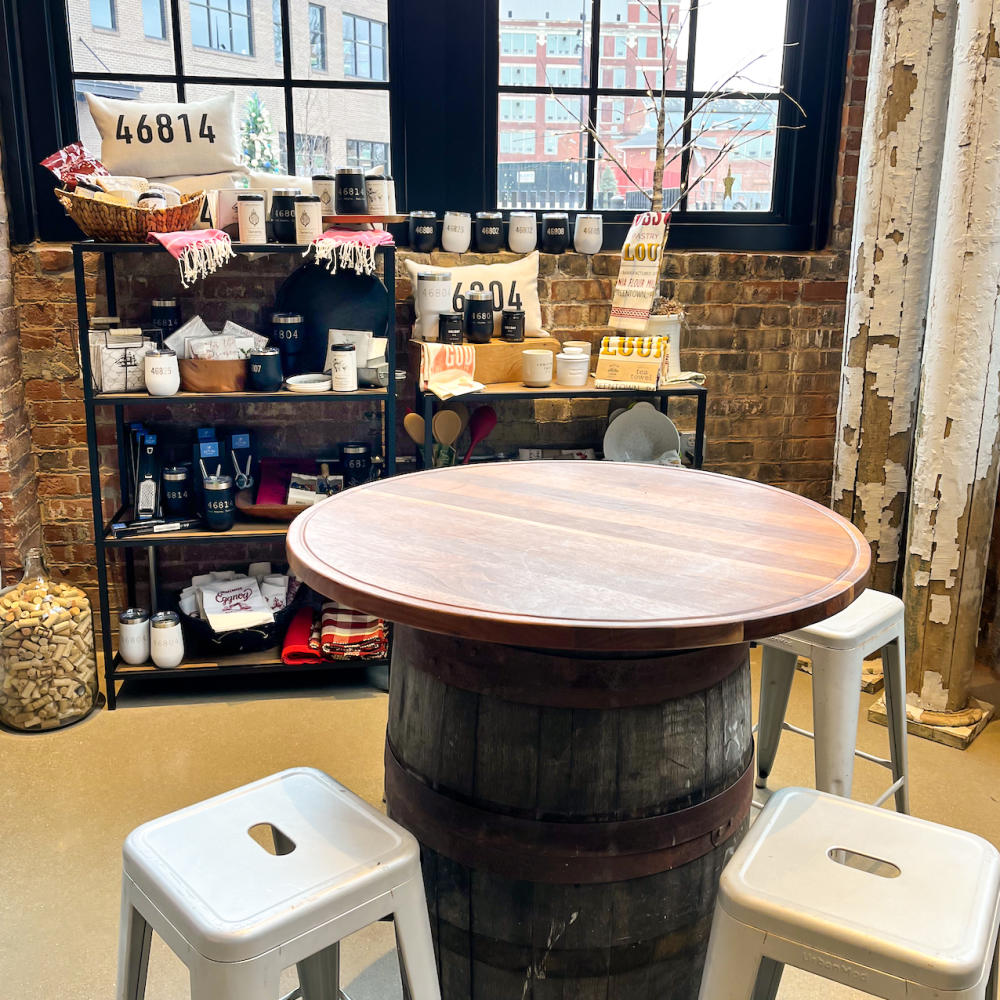 table with wall of merchandise behind it