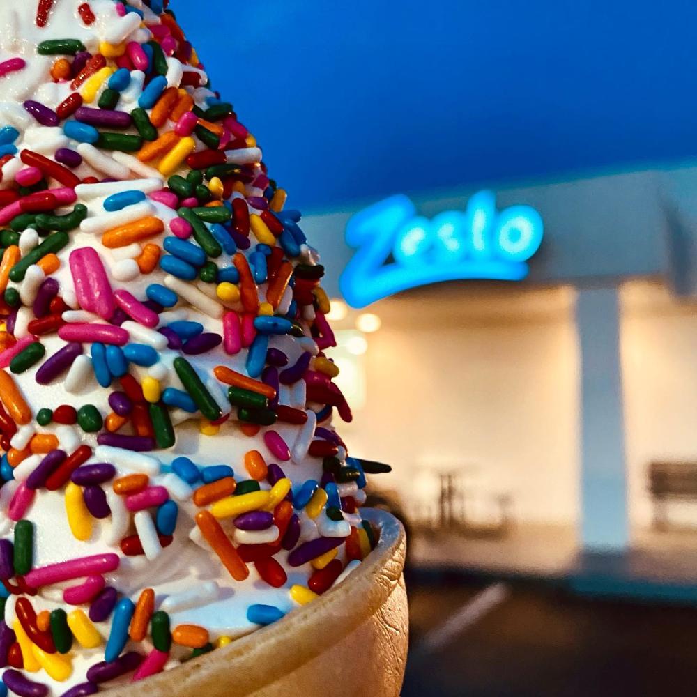 ice cream cone covered in colorful sprinkles