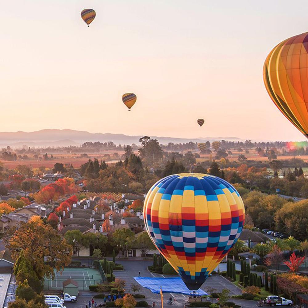 hot air balloons over the town of Yountville