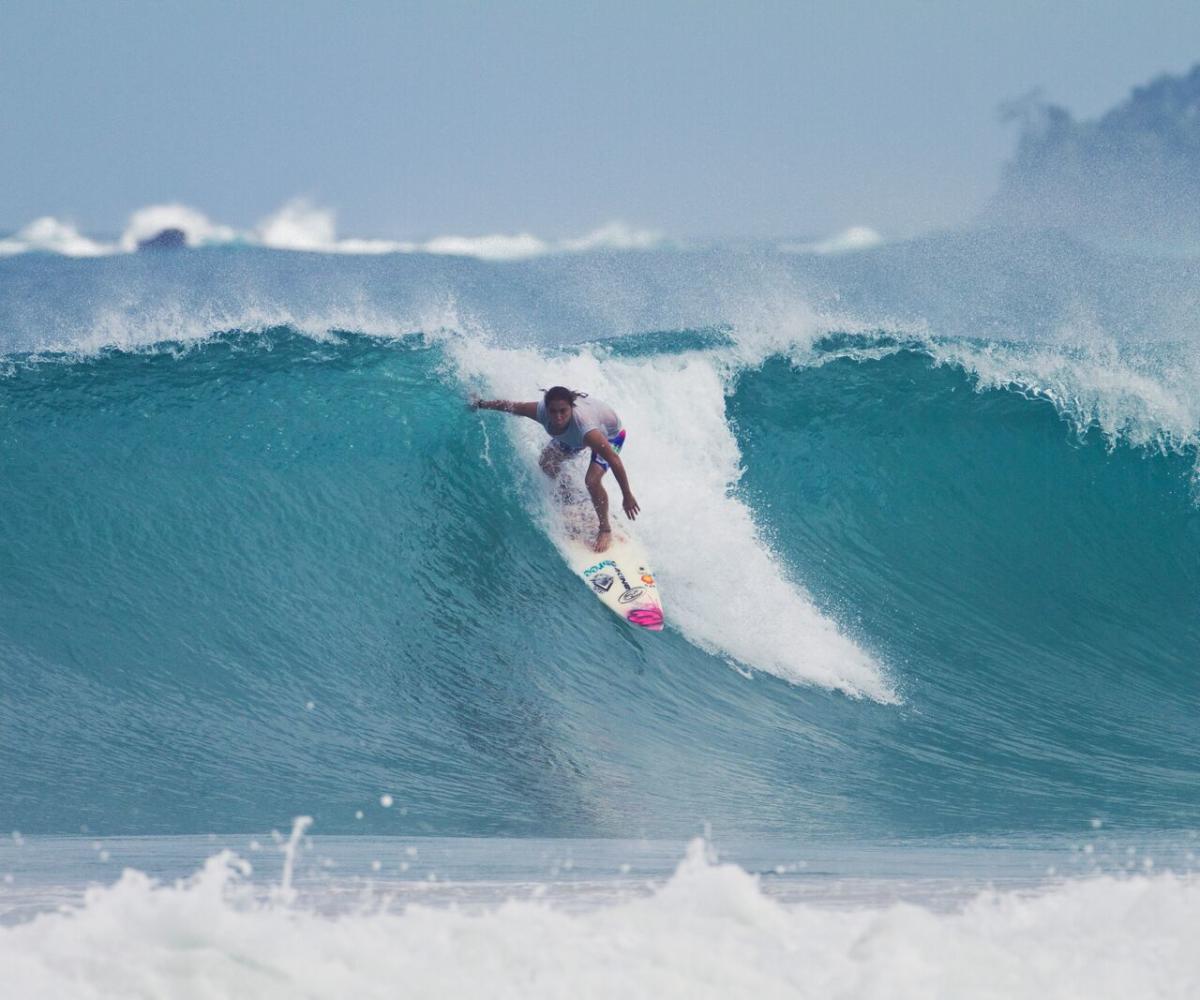 Surfer riding a wave on the beaches of Bastimentos Island, Bocas del Toro, Panama.