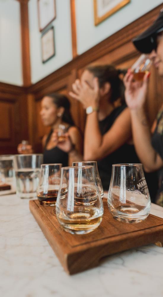 Group of people sampling local rum at Panama City, Panamá
