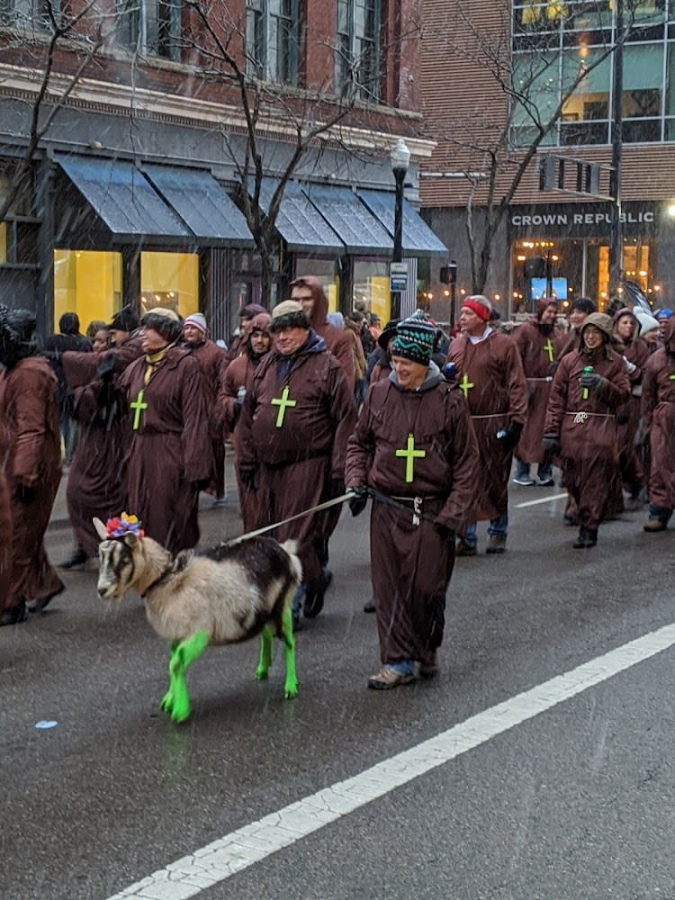 A goat with green legs leading monks in the Bockfest parade in Cincinnati