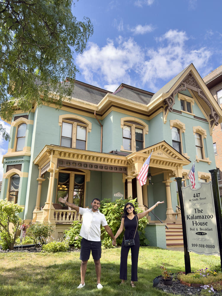 A couple stands in front of the The Kalamazoo House Downtown Hotel & Suites, a historic bed and breakfast, in Downtown Kalamazoo.