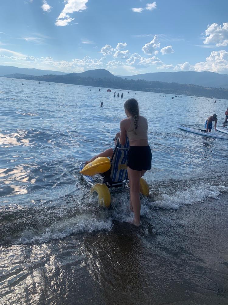 Andrea and Cara going into the lake using a Beach Wheelchair