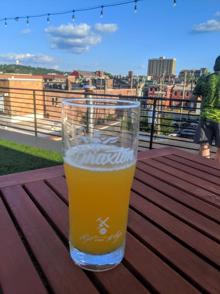 A glass of Braxton beer on a table outside on their rooftop bar in Covington, Ky,.