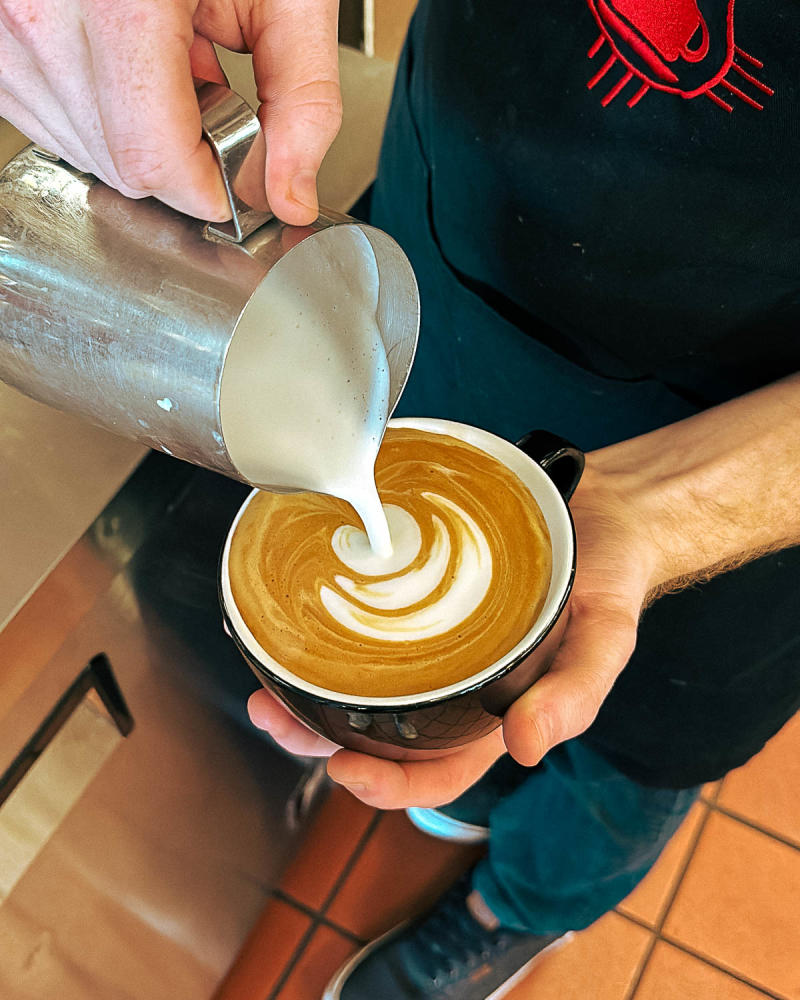 A barista creates latte art at New Mexico Piñon Coffee.