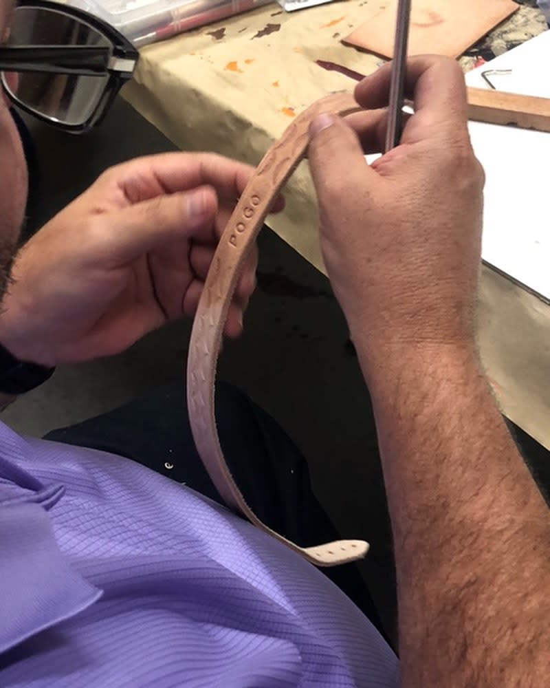 A man makes a leather dog collar in a class at CityArts in Wichita