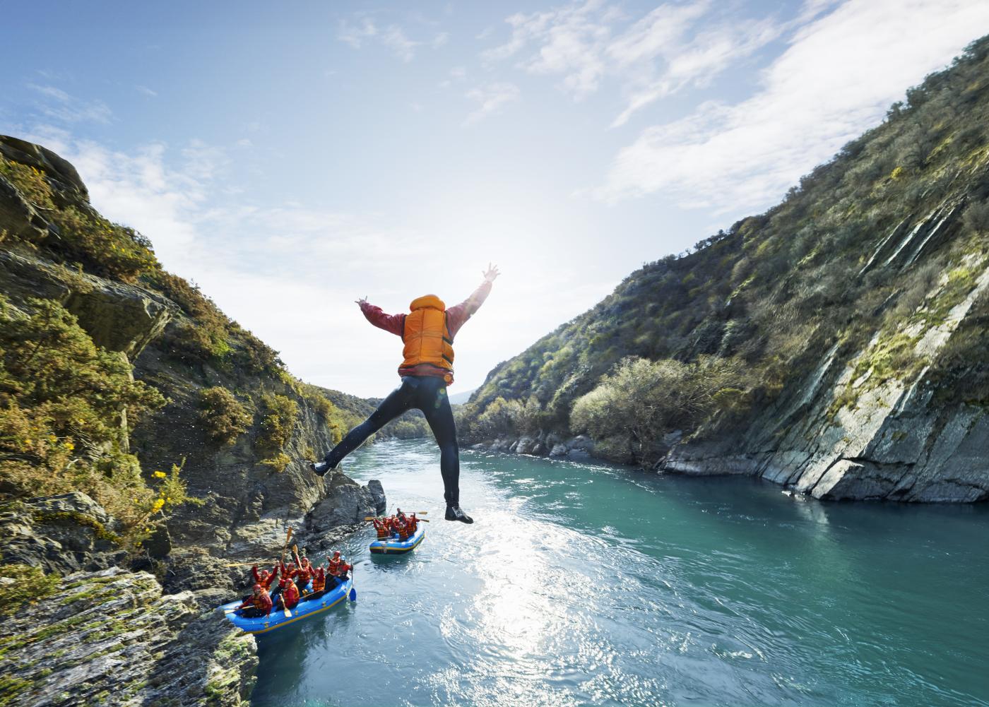 Rafter jumps into water during white water rafting trip