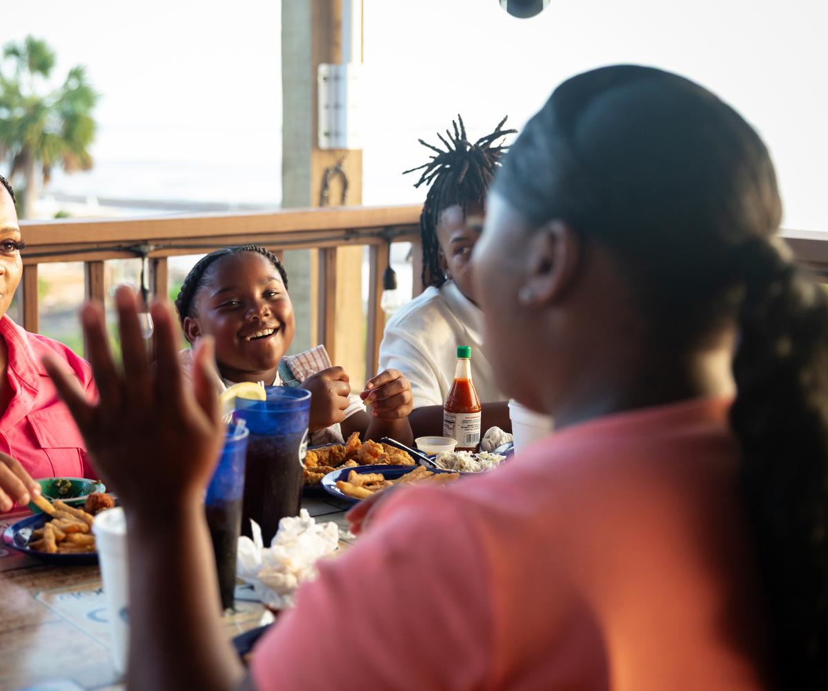 A family enjoys a waterside dinner at a local restaurant