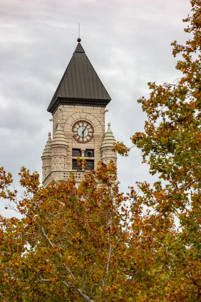 Fall colored leaves obstruct the base of the clocktower at the Wichita-Sedgwick Co. Historical Museum