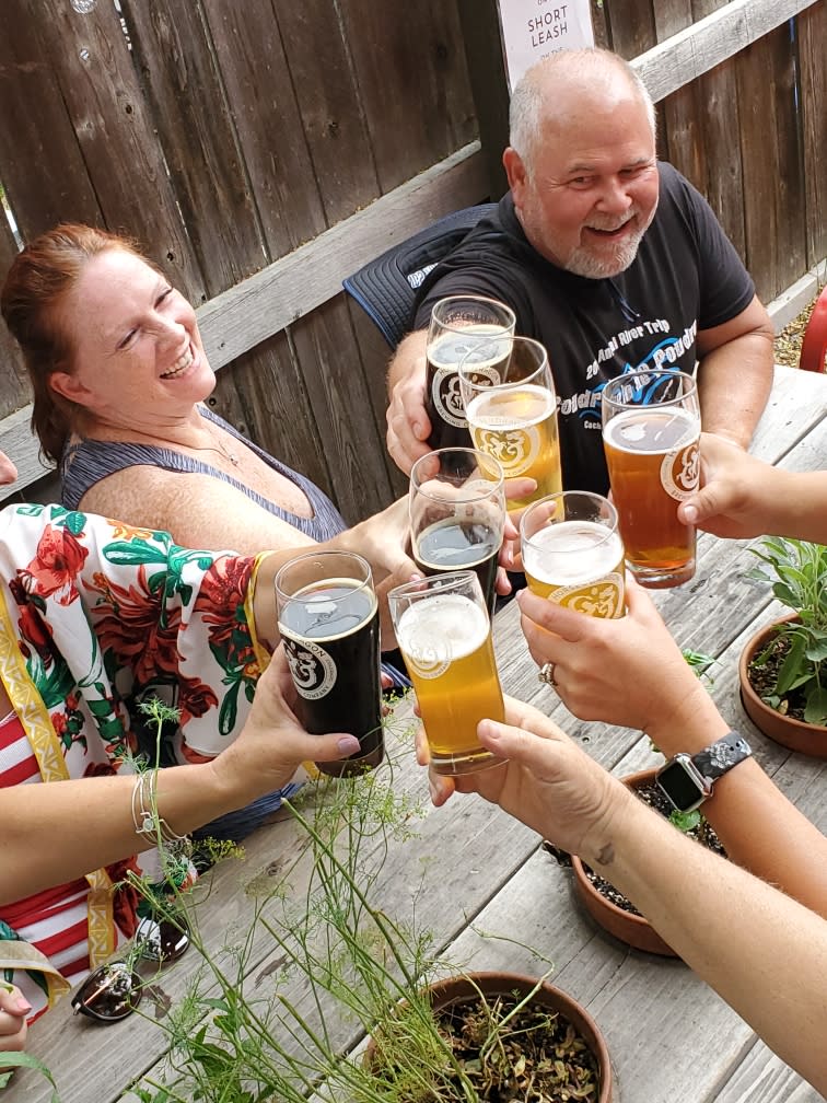 6 people cheersing on a beer and bike tour