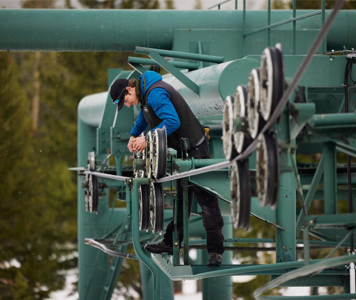 Riley Copeland working on a ski area machine