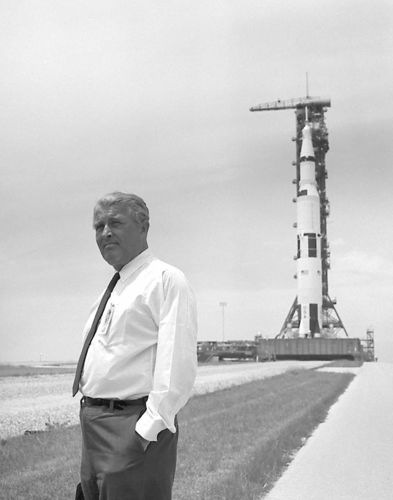 Dr. Wernher von Braun pauses in front of the Saturn V vehicle being readied for the historic Apollo 11 lunar landing mission. The Saturn V vehicle was developed by the Marshall Space Flight Center in Huntsville, Alabama under the direction of von Braun.