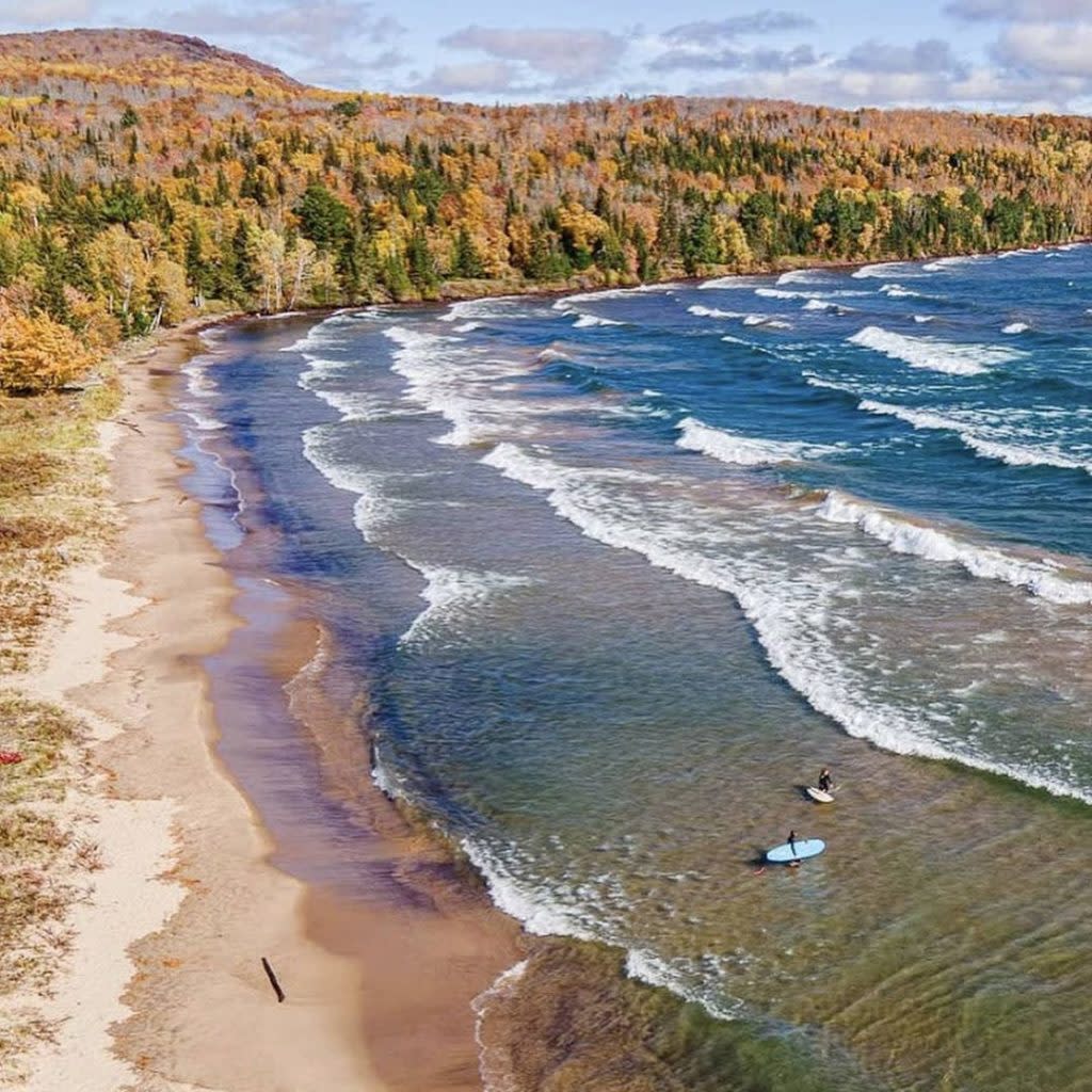 Surfers at Bete Grise Beach in the Fall