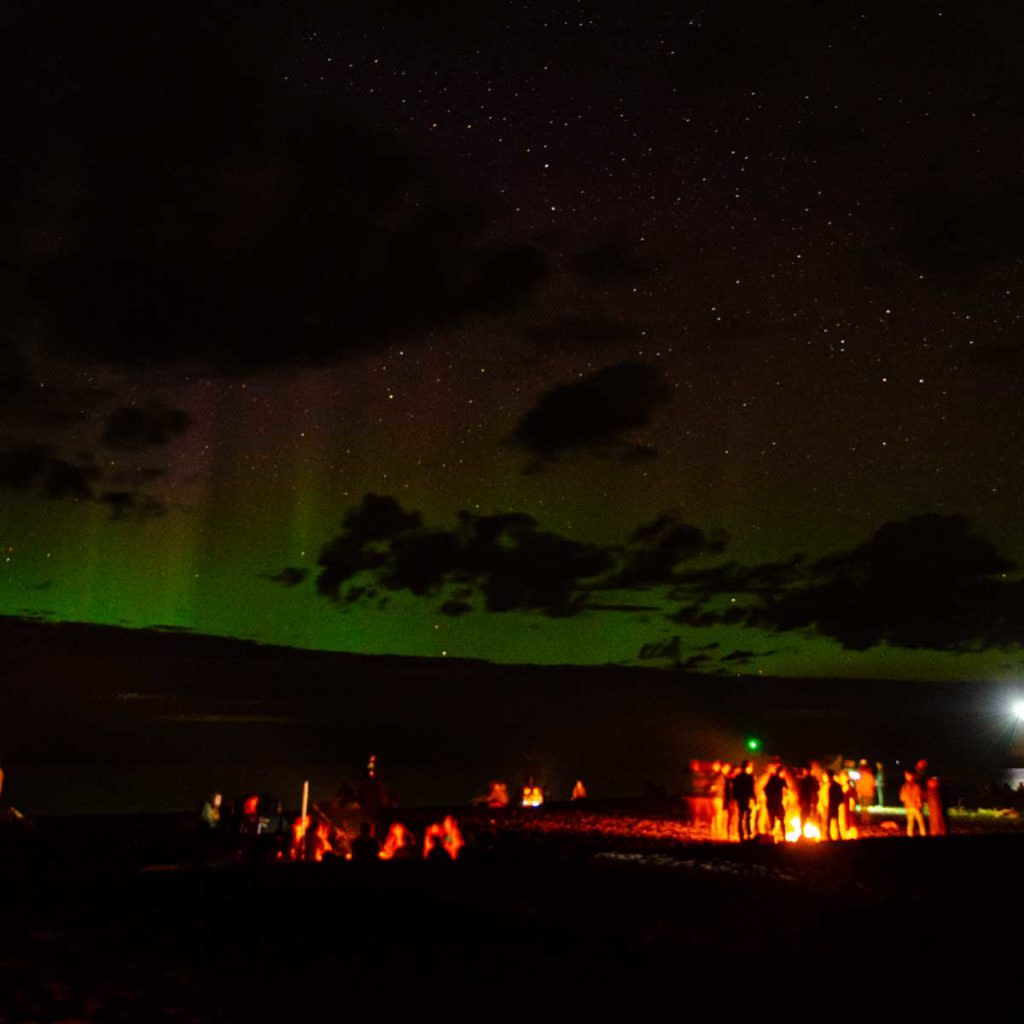 Crowd enjoying a bonfire on Lake Superior