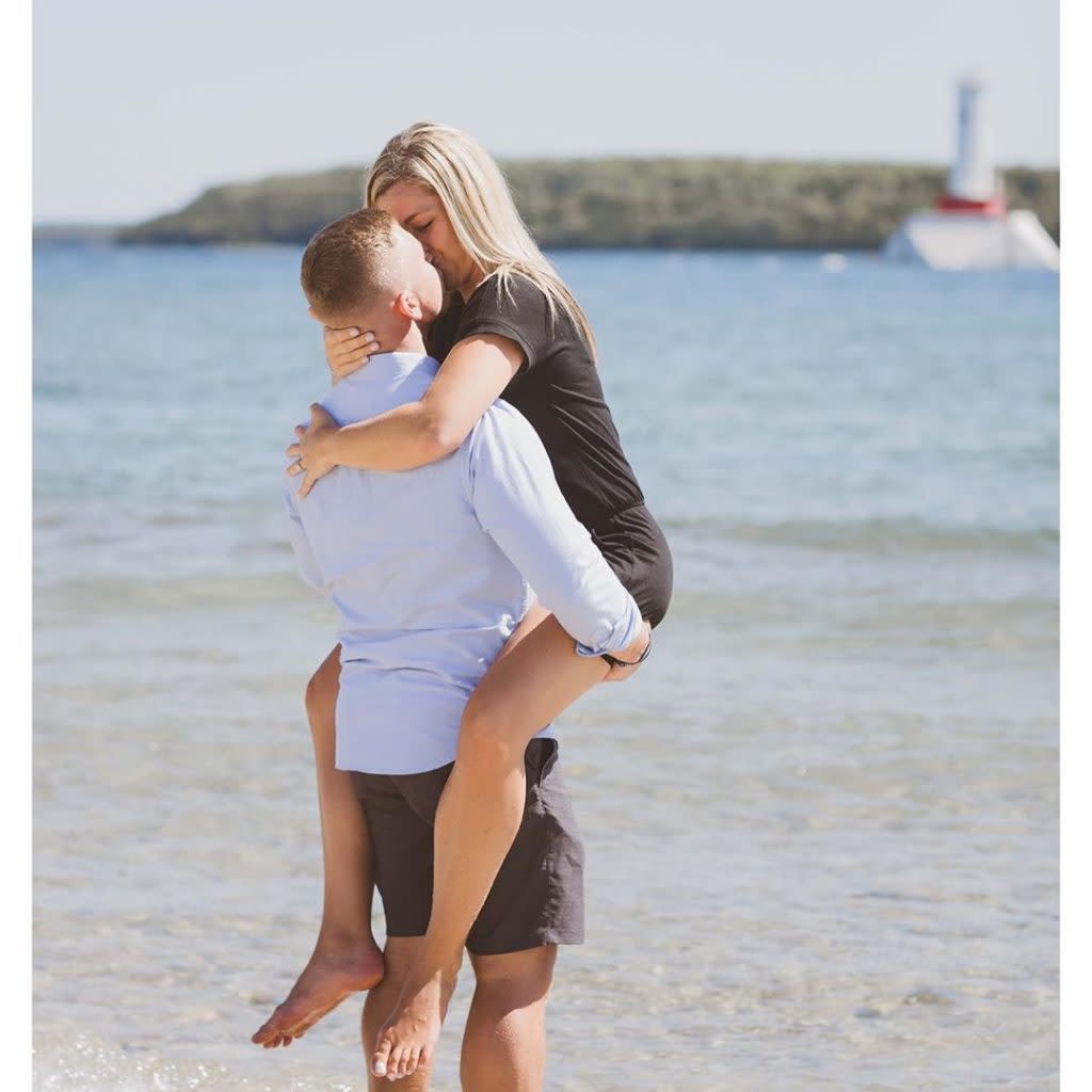 Couple Recently Engaged Kissing in the Surf in Front of Lighthouse on Mackinac Island