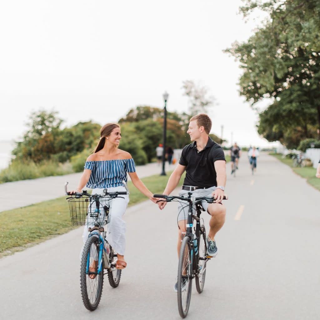 Couple Holding Hands and Riding Bikes on Mackinac Island